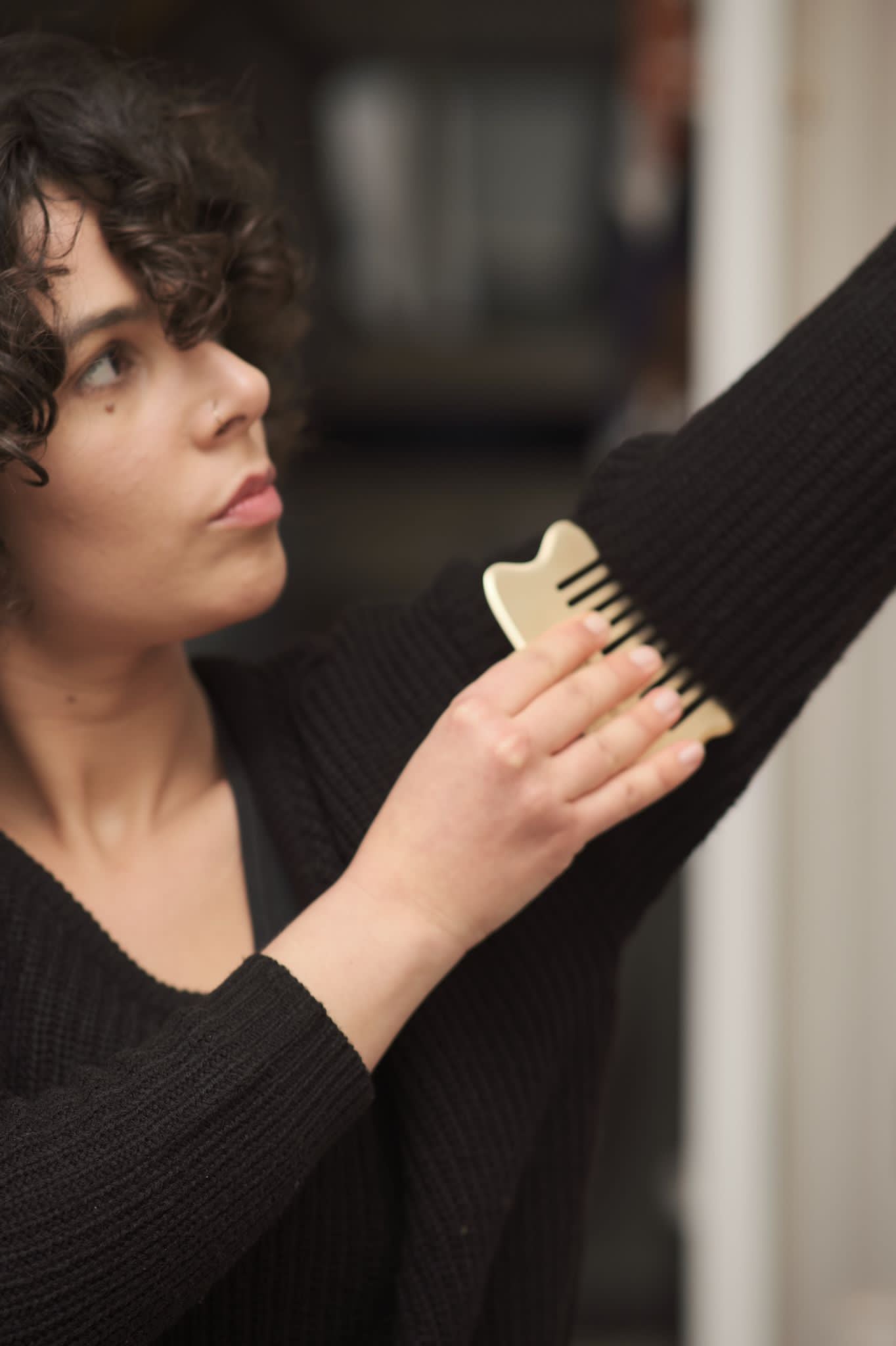 a woman using a body tool from brand Grounded 1002